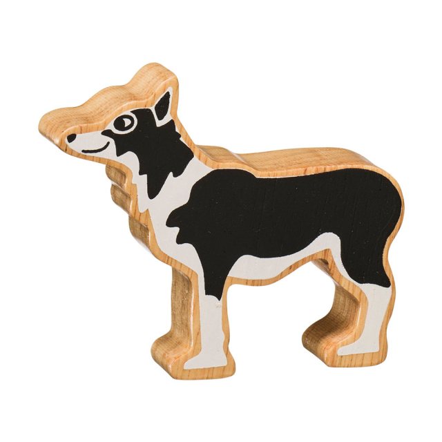 A chunky wooden black/white sheep dog toy figure in profile with a natural wood edge