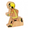 A chunky wooden brown and yellow firefighter toy figure with a natural wood edge