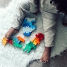 Child playing with selection of Lanka Kade wooden toy jigsaw puzzles