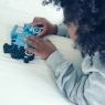 Child playing with blue toy train jigsaw puzzle