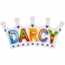 Small, flat wooden name plaque in white crown design with Darcy spelt in multicoloured letters