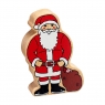 A chunky wooden Father Christmas toy figure in profile with a natural wood edge