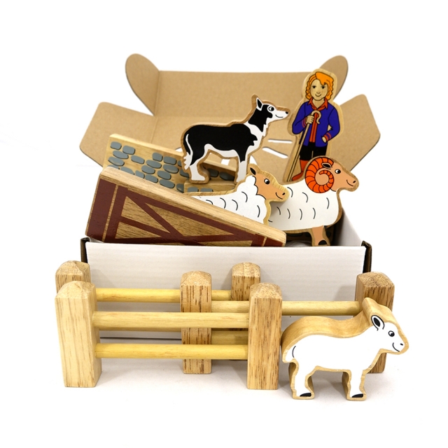 A childrens wooden toy sheep herding playset containg animals, people and fences.