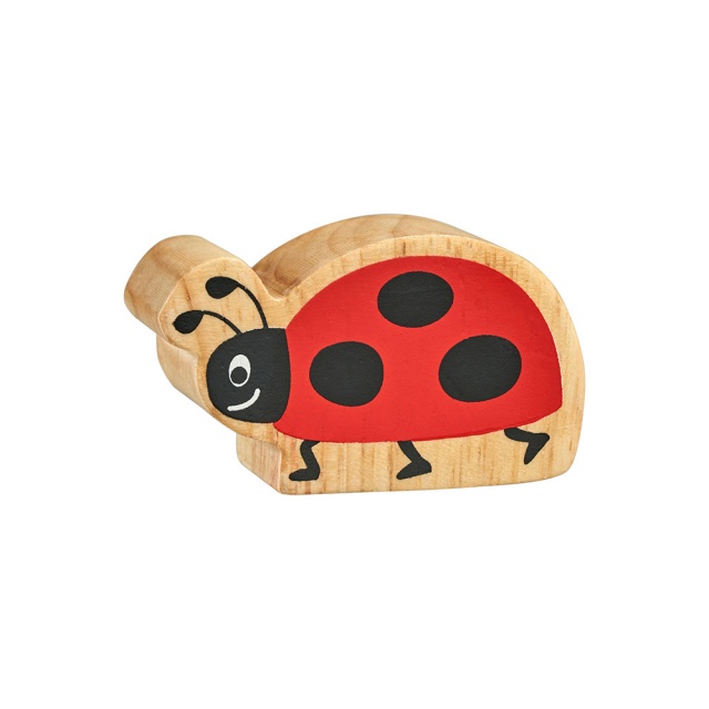 A chunky wooden red and black ladybird toy figure with a natural wood edge.
