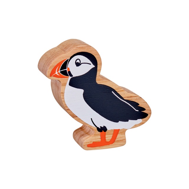 A chunky natural wood black and white puffin figure in profile with a natural wood edge