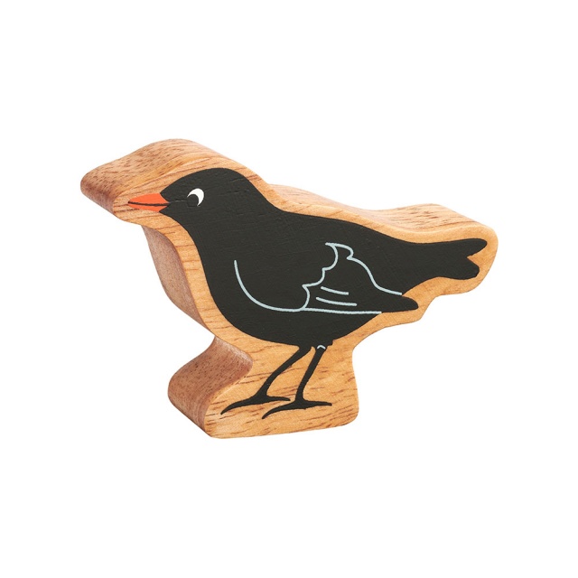 A chunky wooden blackbird toy figure in profile with a natural wood edge