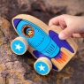 Child playing with a blue rocket push along