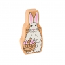 A chunky wooden white and pink Easter bunny toy figure in profile