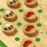 A wooden board game with ten bee and ladybird game pieces