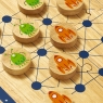 A wooden board game with 10 alien and rocket game pieces