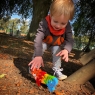 Child playing with a wooden toy tiger jigsaw puzzle