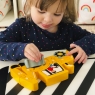 Child playing with a ten piece chunky wooden yellow digger 1-10 jigsaw puzzle
