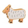 A chunky wooden white sheep toy figure in profile with a natural wood edge