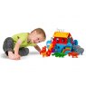 Child playing with small Noah's ark playset on the floor