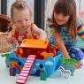 Child playing with small Noah's ark playset on the floor