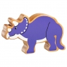 A wooden toy purple triceratops dinosaur in profile with a natural wood grain edge