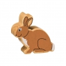 A wooden toy brown rabbit in profile with a natural wood grain edge