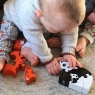 Child playing with the four piece black and white panda wooden jigsaw puzzle