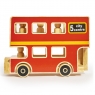 Red wooden double decker bus playset with 3 peg people sat on bricks with landscape background