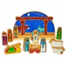 Nativity with wooden blue semi-circle backdrop, with colourful biblical character figures/ animals