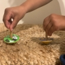 Child playing with selection of Lanka Kade spinning tops