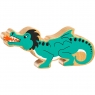 A chunky wooden green dragon toy figure in profile with a natural wood edge
