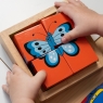 Child playing with Lanka Kade minibeast block puzzle