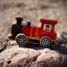 Chunky wooden red train painted with driver on the beach