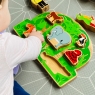 Child playing with jungle shape sorter toy on the floor