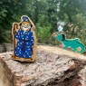 A chunky wooden blue and yellow toy wizard figure
