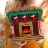 A chunky wooden fireplace with stockings figure in profile with a natural wood edge