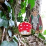 Toy toadstool and hermit in a tree